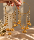 Close-up of Dil Bangles pair with heart chains and gold bell charms