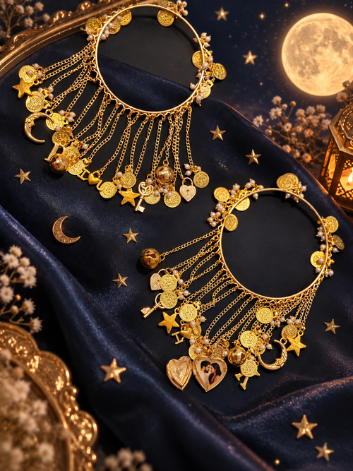 Pair of gold-tone Chaand Sitara Bangles with moon, star, initial and photo charms on a dark blue backdrop