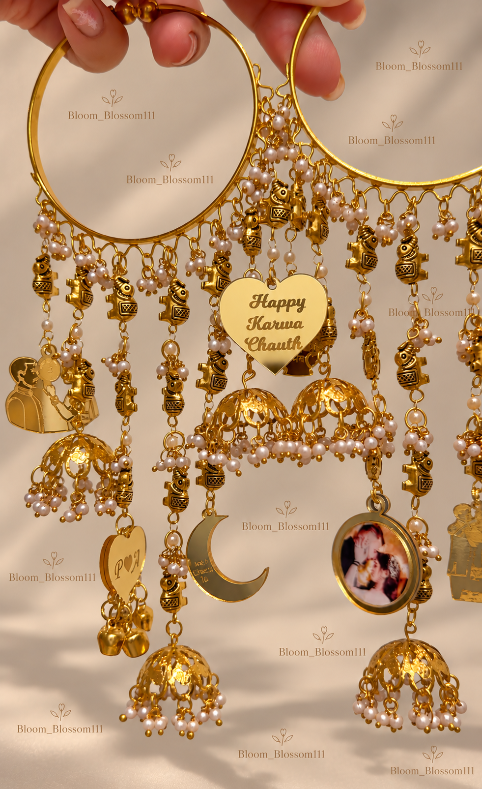 Close-up of two adjustable charm bangles with Karwa Chauth and photo charms