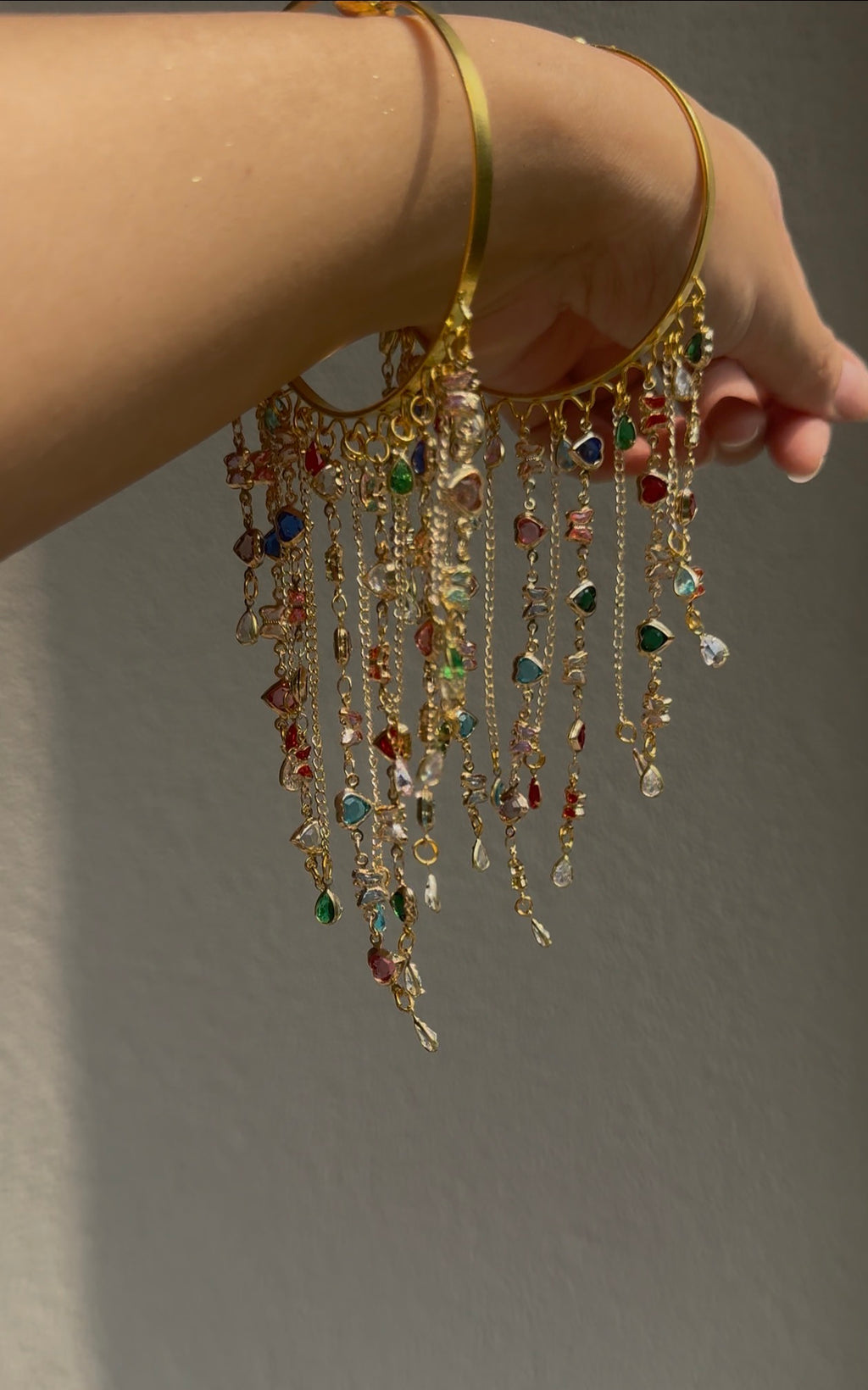 Nazakat Bangles pair with multicoloured dangling chains, worn on wrist